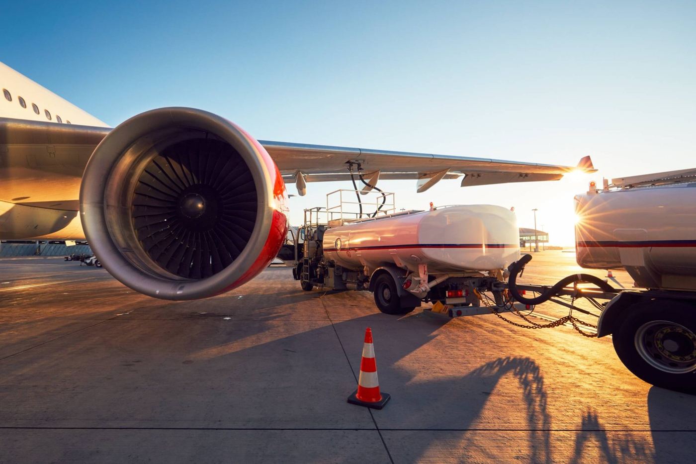 Refueller truck beside an aircraft engine